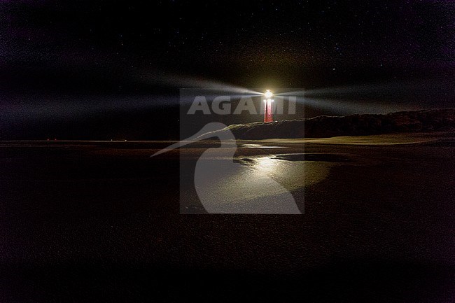 Lighthouse of Dutch Wadden Island Texel during the night, with night full of stars. stock-image by Agami/Wil Leurs,