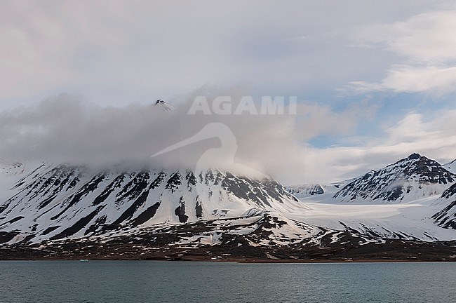 Cloud cover above ice streaked mountains bordering Kongsfjorden near Ny-Alesund. Kongsfjorden, Spitsbergen Island, Svalbard, Norway. stock-image by Agami/Sergio Pitamitz,