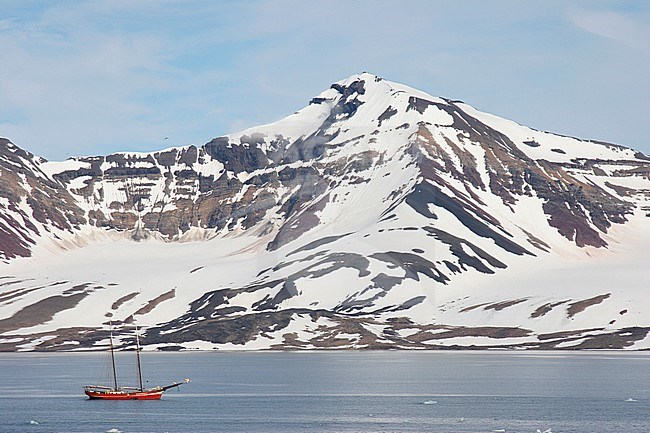 Sailing boat in landscape Svalbard, Arctic Norway, with snow-covered mountains in the background. stock-image by Agami/Chris van Rijswijk,