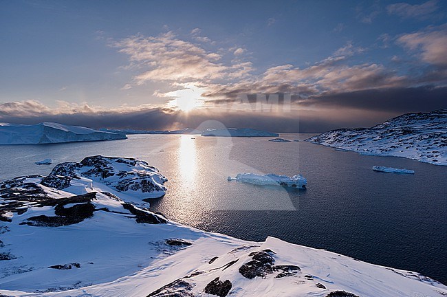 A view of Ilulissat icefjord, an UNESCO World Heritage Site, at sunset. Ilulissat Icefjord, Ilulissat, Greenland. stock-image by Agami/Sergio Pitamitz,