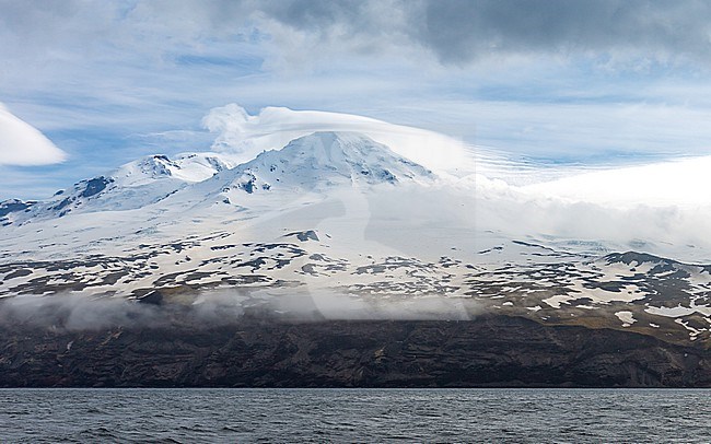 Despite the bad weather conditions, the clouds opened up around Beerenberg on Jan Mayen. The photo was taken from M.V. Plancius. This is the northernmost volcano on earth. and last active in 1985 stock-image by Agami/Onno Wildschut,