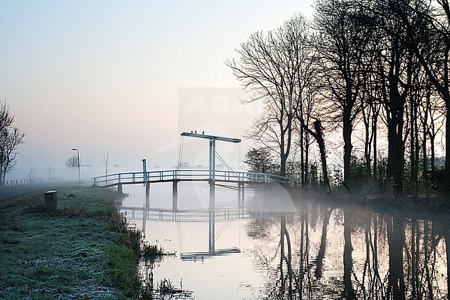 Lifting bridge in a misty landscape at Ouderkerk stock-image by Agami/Marc Guyt,