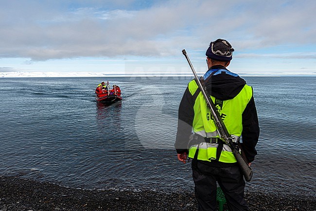 An armed guide on the shore of Mushamna awaits for cruise tourists. Spitsbergen Island, Svalbard, Norway. stock-image by Agami/Sergio Pitamitz,