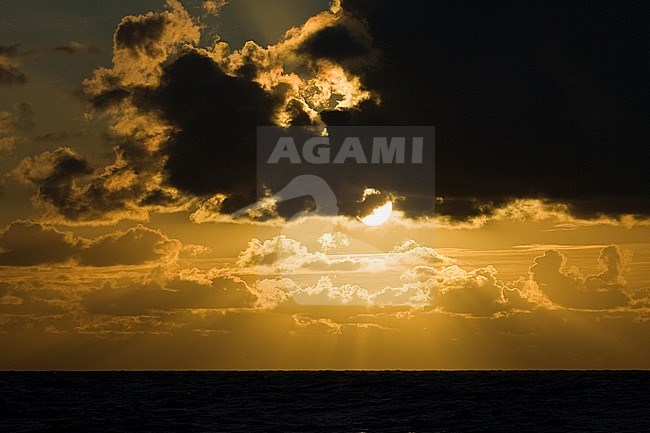 Golden sunset and dark clouds over Wadden Sea in summer stock-image by Agami/Marc Guyt,
