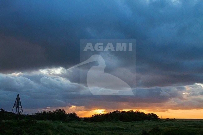 Dawn at Schiermonnikoog, Netherlands. Nature image from the Netherlands, with thick clouds hanging over the Dutch Wadden Sea island. stock-image by Agami/Menno van Duijn,