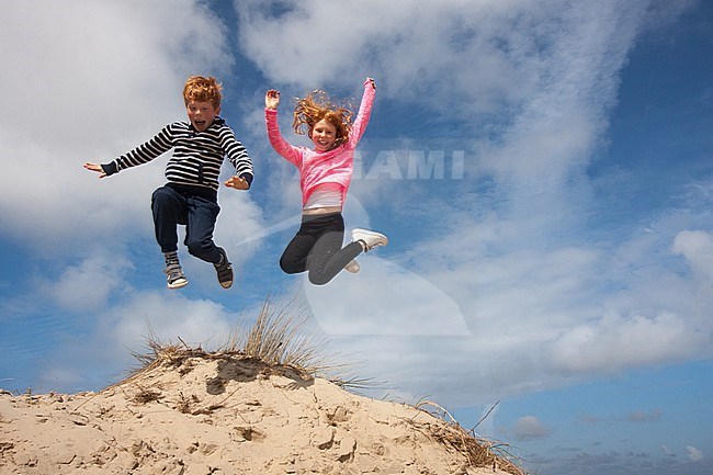 Jumping kids in the dunes on Texel, Netherlands stock-image by Agami/Bas Haasnoot,